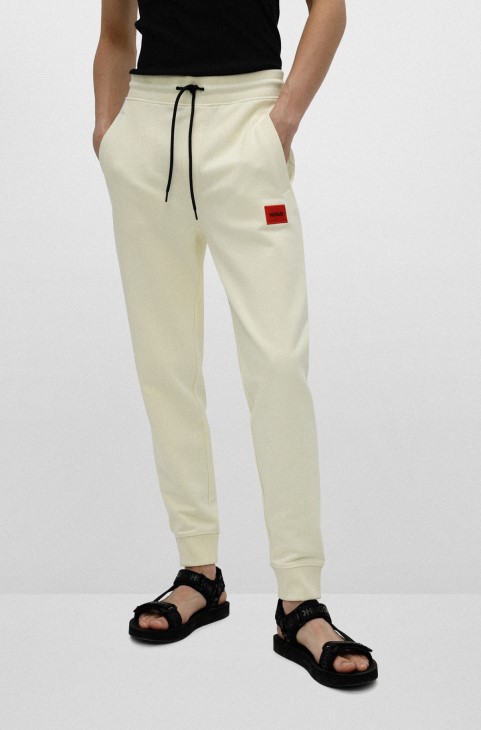 Βαμβακερό παντελόνι φόρμας Hugo Boss ανοιχτό κίτρινο με κόκκινο λογότυπο